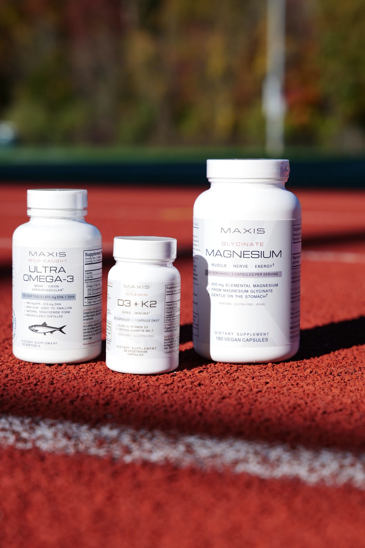 MAXIS daily foundation supplements on a running track