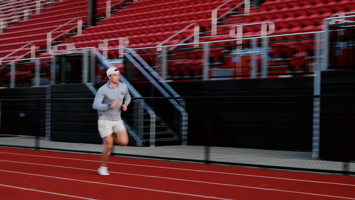 MAXIS co-founder running on the track at golden hour